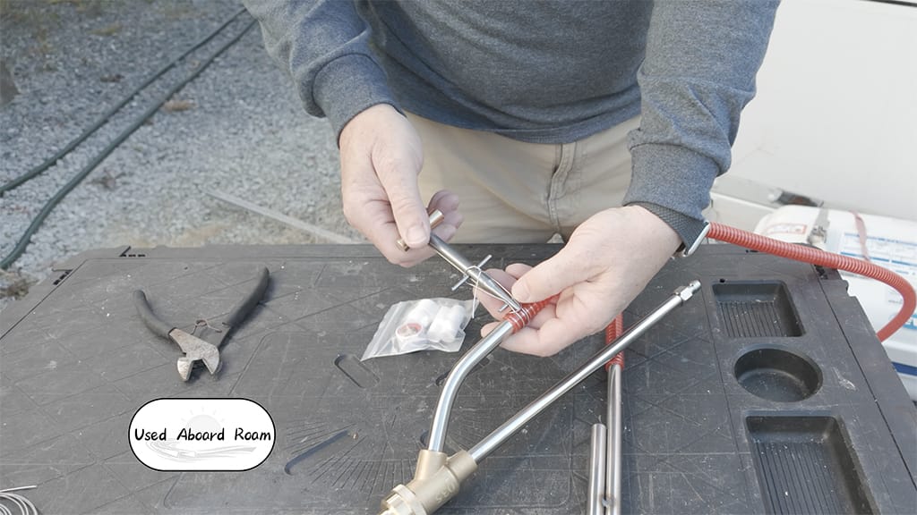 ClampTite wire clamp tool securing a wet sandblaster intake hose for strong vacuum