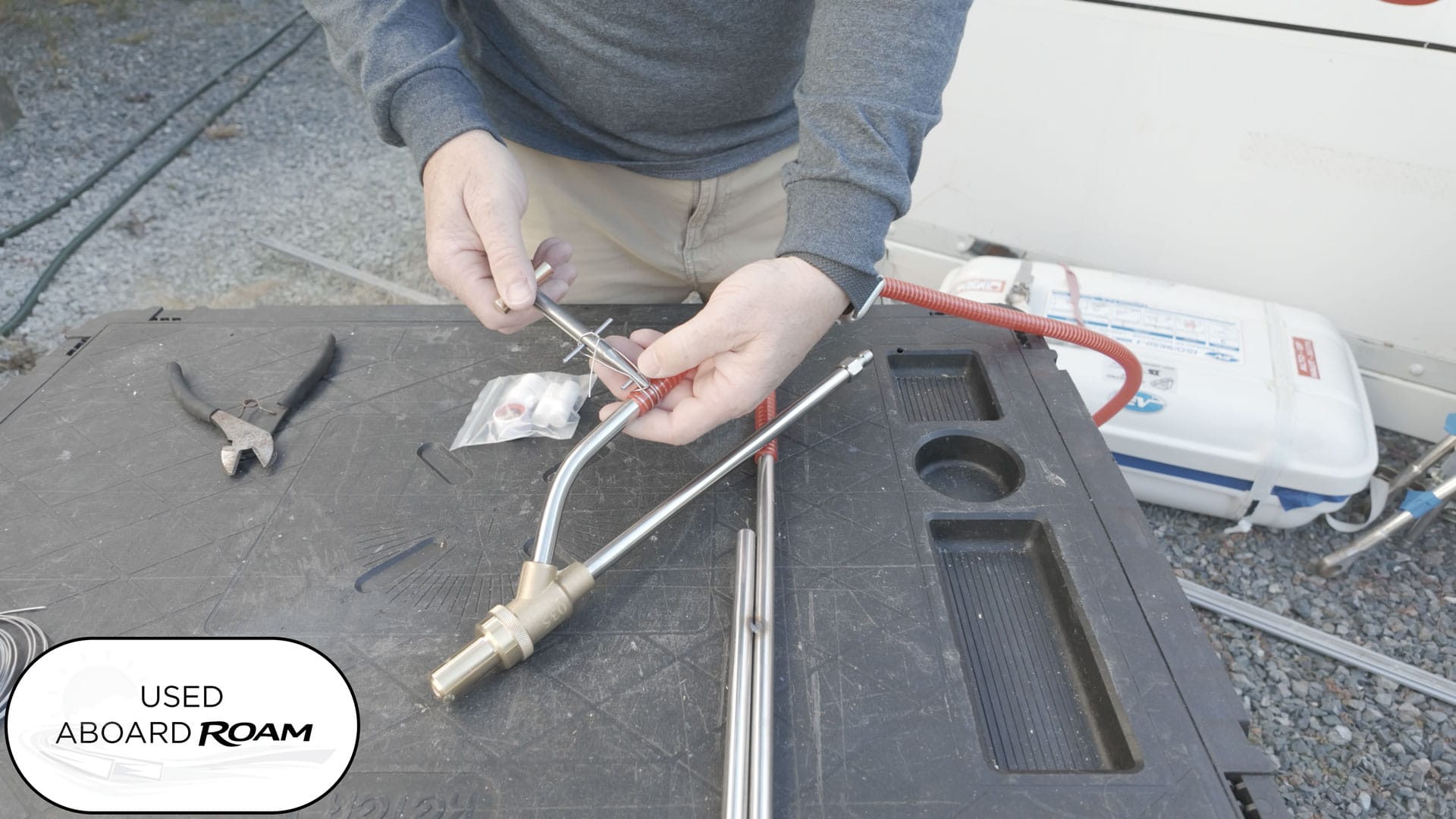 ClampTite wire clamp tool securing a wet sandblaster intake hose for strong vacuum